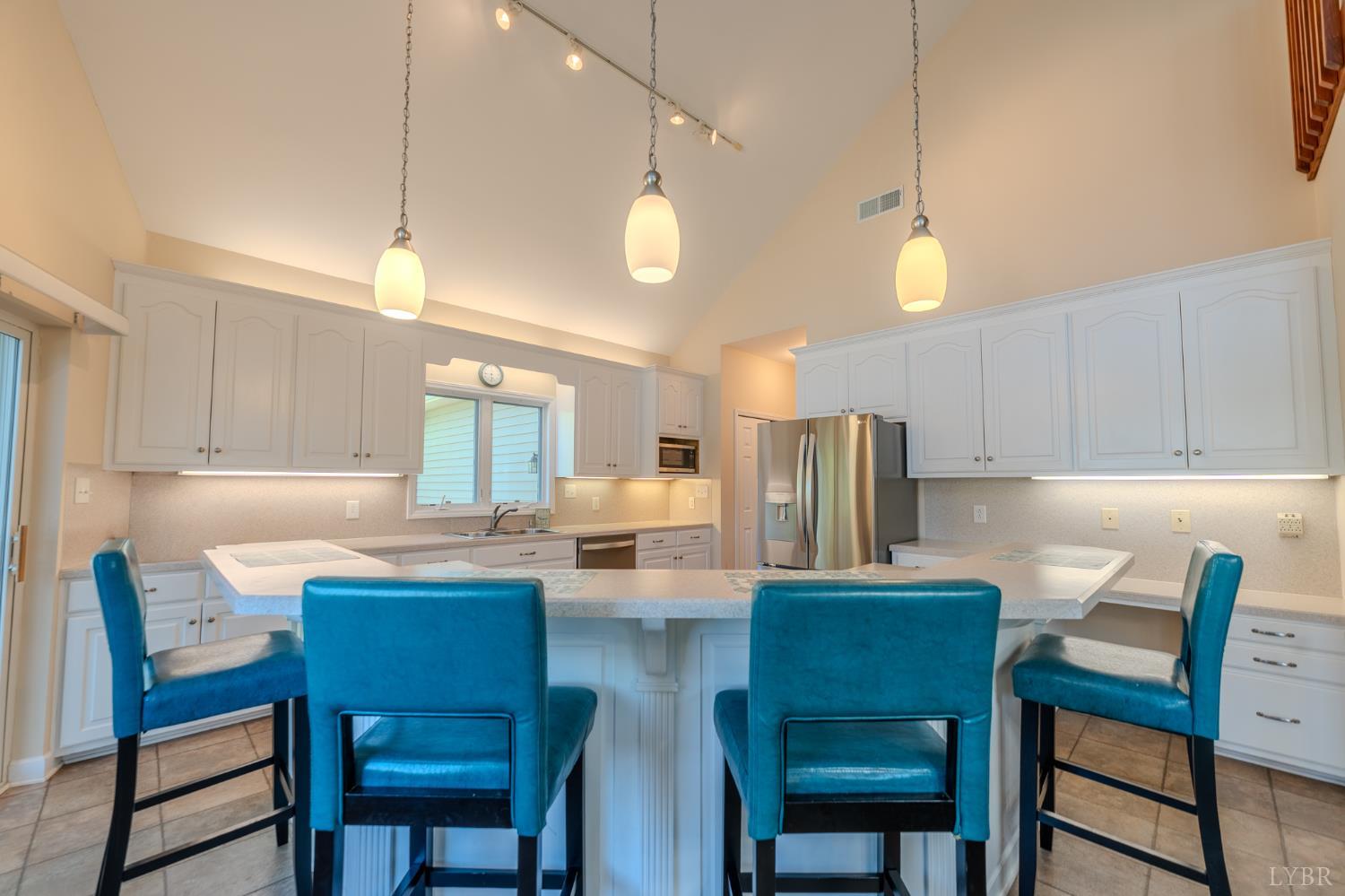 1269 Runaway Bay Road Lynch Station, VA 24571 - Photo 13 of 82 a kitchen with a dining table chairs and refrigerator