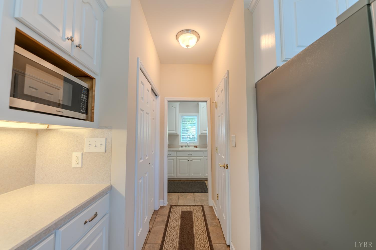 1269 Runaway Bay Road Lynch Station, VA 24571 - Photo 18 of 82 a view of a hallway with entryway wooden floor and cabinet