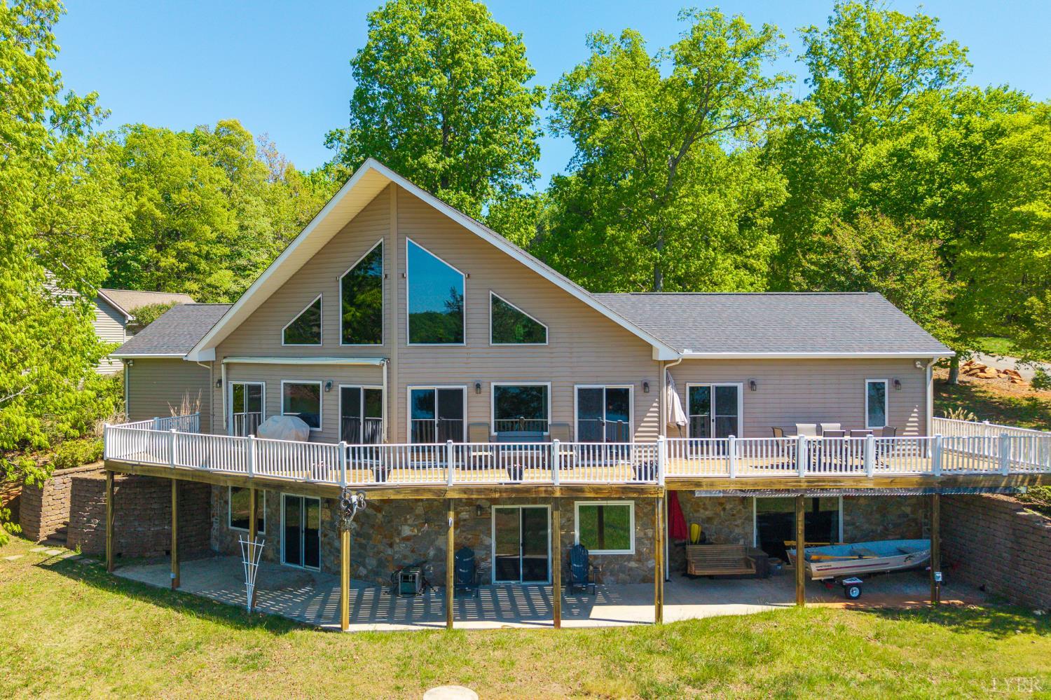 1269 Runaway Bay Road Lynch Station, VA 24571 - Photo 2 of 82 a view of a house with swimming pool next to a yard