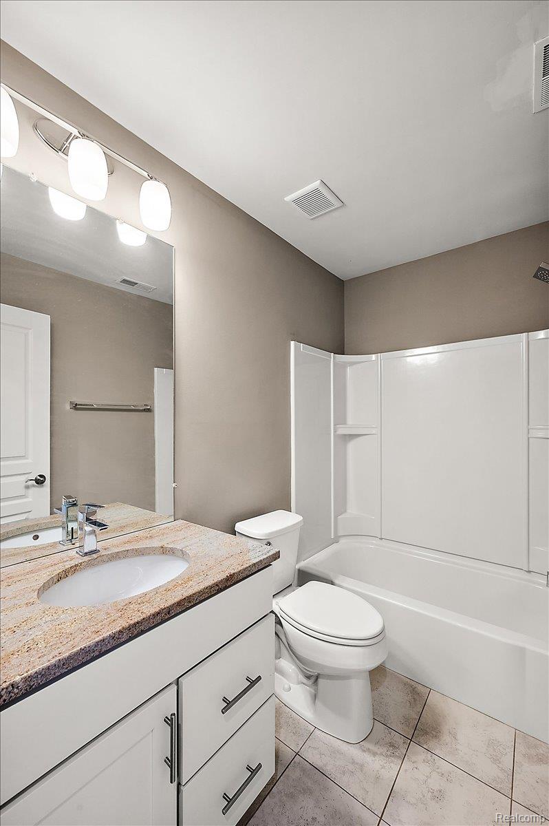 2877 Hartwick Drive Rochester, MI 48307 - Photo 41 of 44 Bathroom with vanity, shower / washtub combination, and light tile patterned flooring
