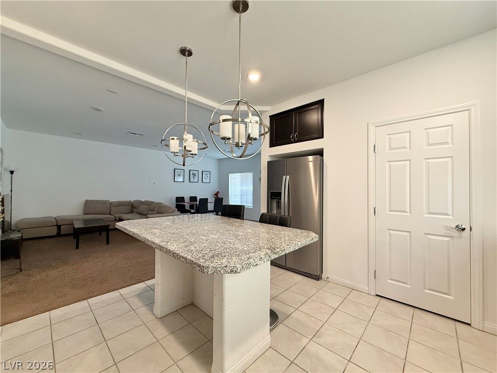 7777 South Westwind Road Las Vegas, NV 89139 - Photo 29 of 46 A versatile kitchen island with ample counter space anchors this open-concept living area.