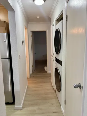 a view of a hallway with washer and dryer