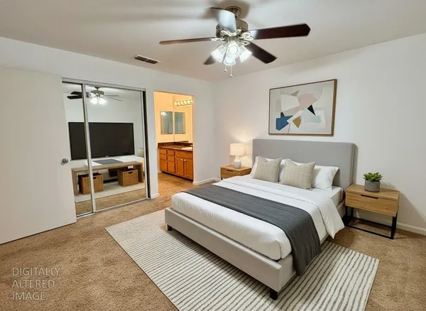 a spacious bedroom with a large bed a flat tv screen and a dresser