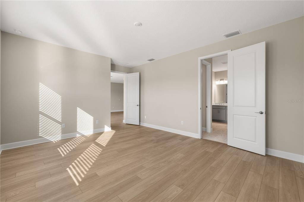 2181 Longliner Loop Wesley Chapel, FL 33543 - Photo 17 of 44 a view of empty room with wooden floor