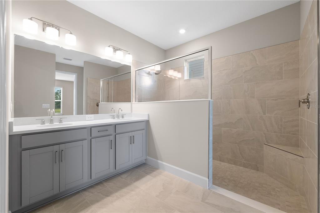 2181 Longliner Loop Wesley Chapel, FL 33543 - Photo 18 of 44 a bathroom with a double vanity sink and a mirror