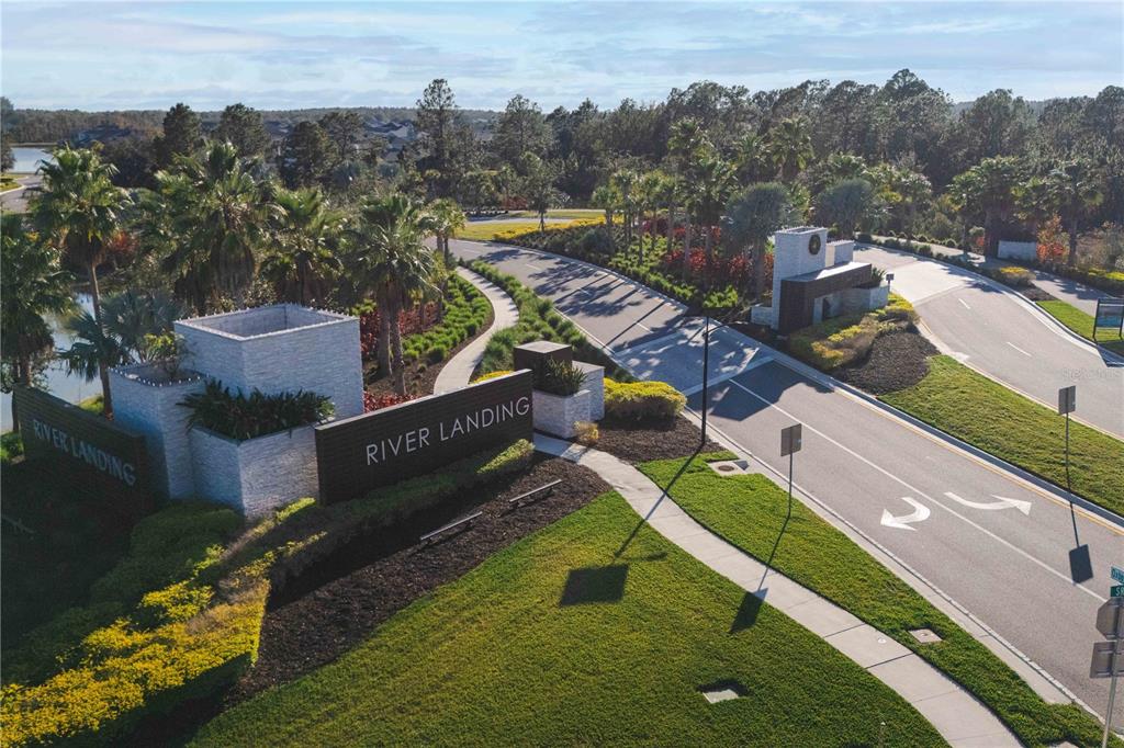 2181 Longliner Loop Wesley Chapel, FL 33543 - Photo 2 of 44 an aerial view of a house with a garden and lake view