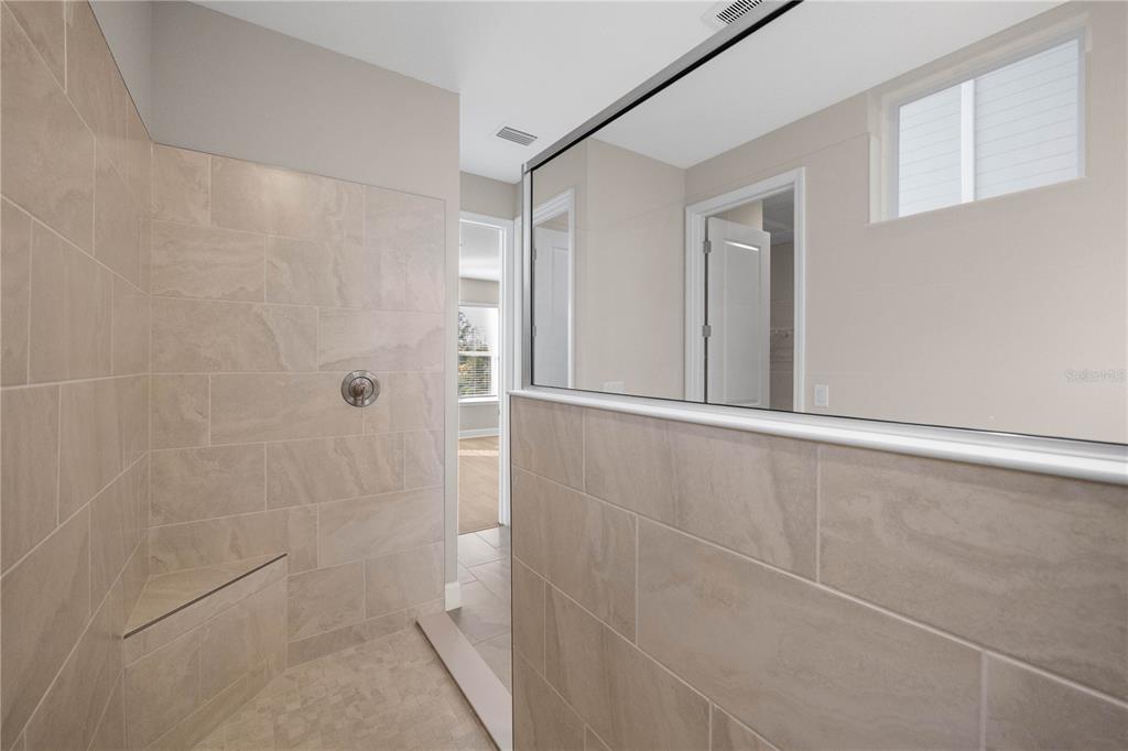 2181 Longliner Loop Wesley Chapel, FL 33543 - Photo 21 of 44 a bathroom with a shower and toilet