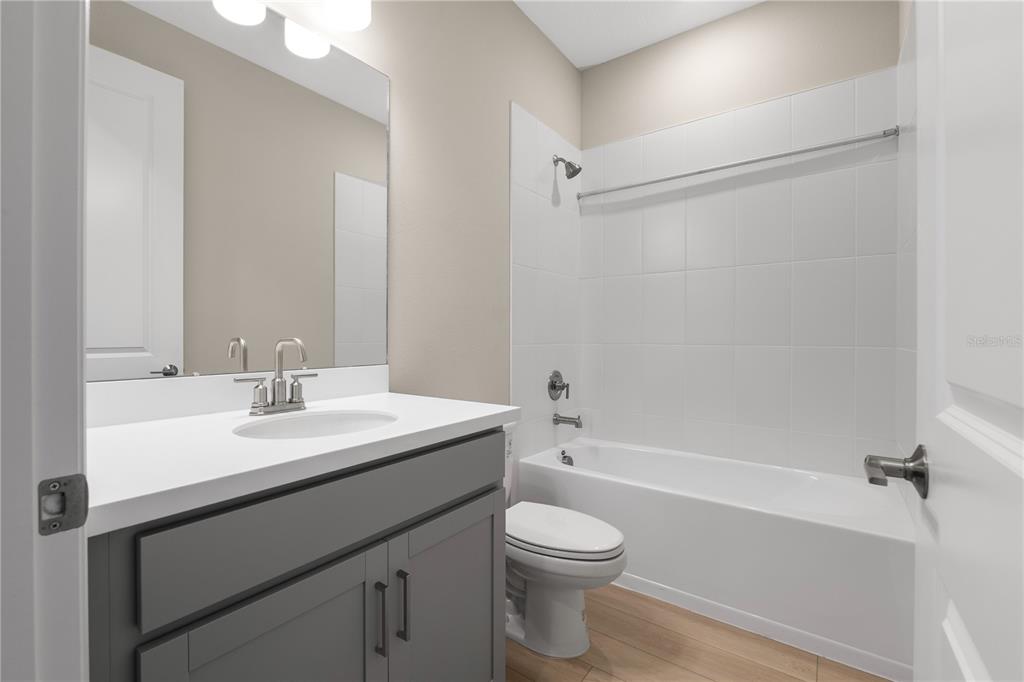 2181 Longliner Loop Wesley Chapel, FL 33543 - Photo 29 of 44 a bathroom with a sink a toilet and shower