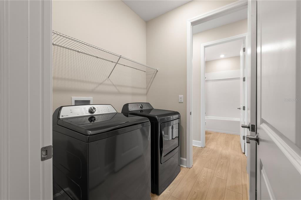 2181 Longliner Loop Wesley Chapel, FL 33543 - Photo 30 of 44 a utility room with dryer and washer