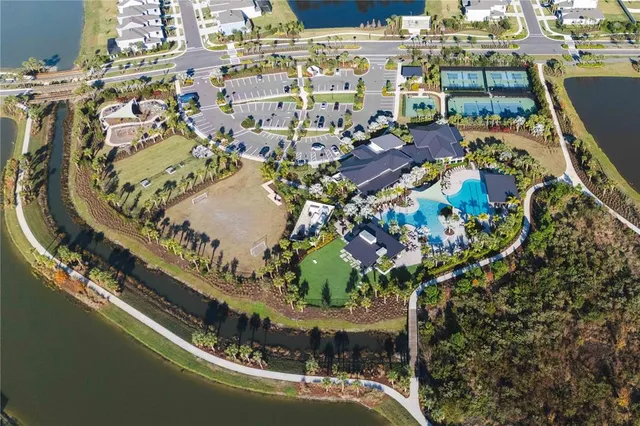 an aerial view of residential houses with outdoor space and swimming pool