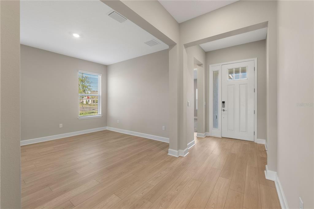 2181 Longliner Loop Wesley Chapel, FL 33543 - Photo 4 of 44 a view of an empty room with wooden floor and a window