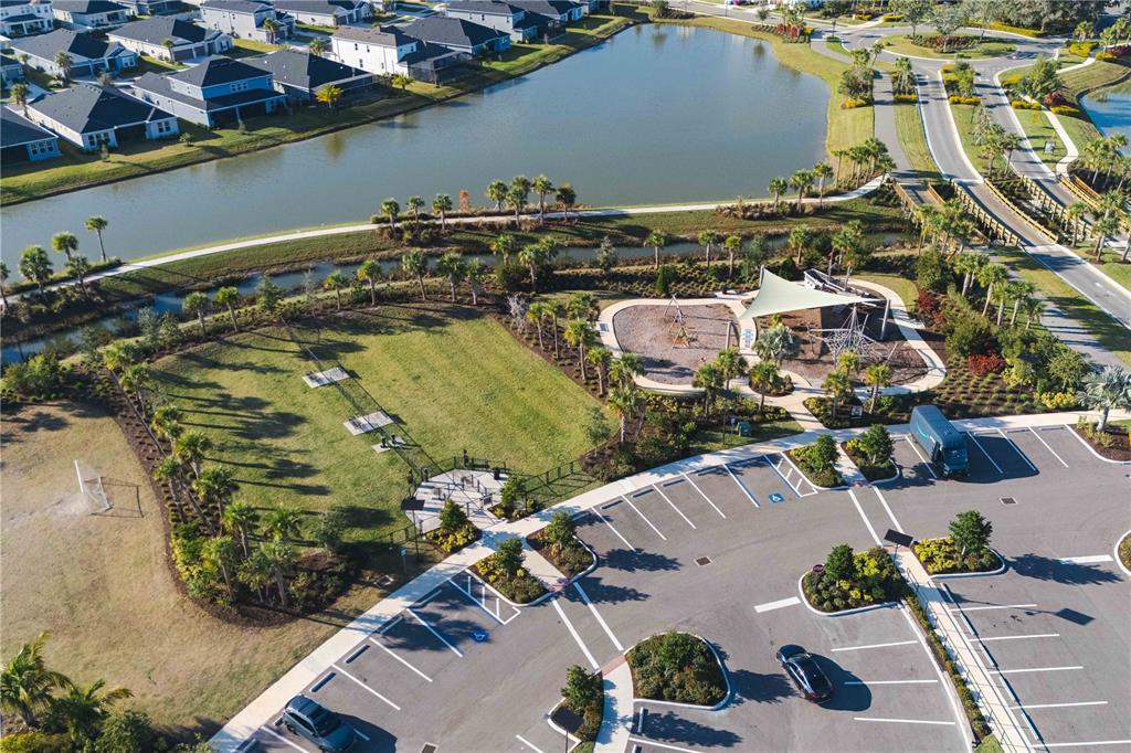 2181 Longliner Loop Wesley Chapel, FL 33543 - Photo 42 of 44 an aerial view of a house with a yard and lake view