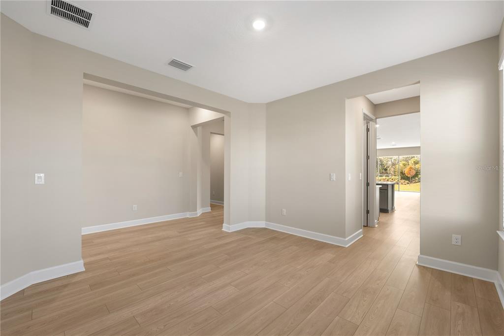 2181 Longliner Loop Wesley Chapel, FL 33543 - Photo 6 of 44 wooden floor in an empty room