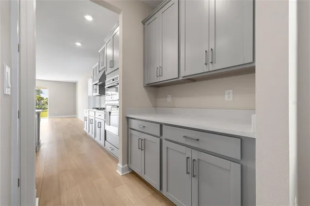 a view of a kitchen with wooden floor