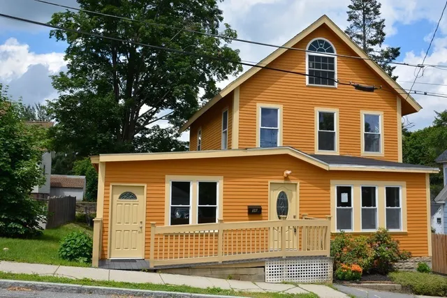 a front view of a house with a yard