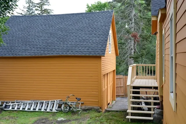 a view of a patio with wooden wall and stairs