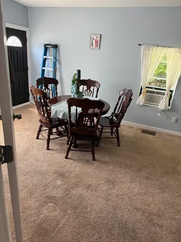 a view of a livingroom with furniture and a window
