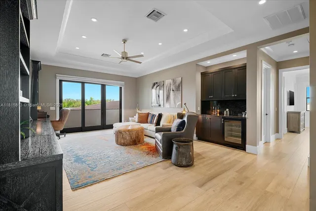 a living room with furniture large window and flat screen tv