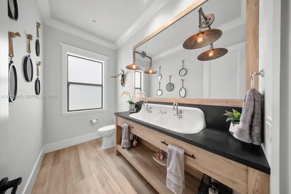 a bathroom with a sink mirror and shower