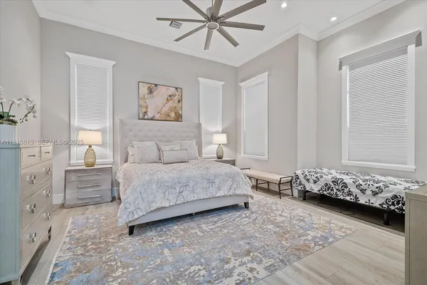 a view of a dining room with furniture a chandelier and wooden floor