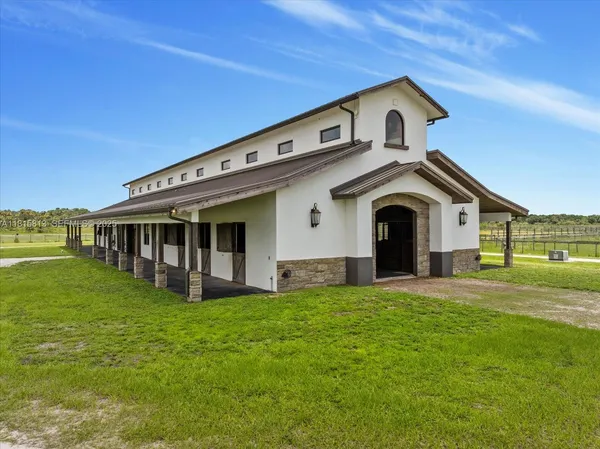 an aerial view of a house with garden space and street view
