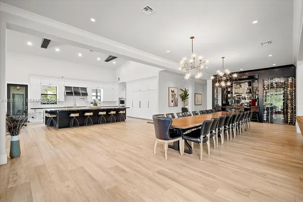 a view of a dining room with furniture and chandelier