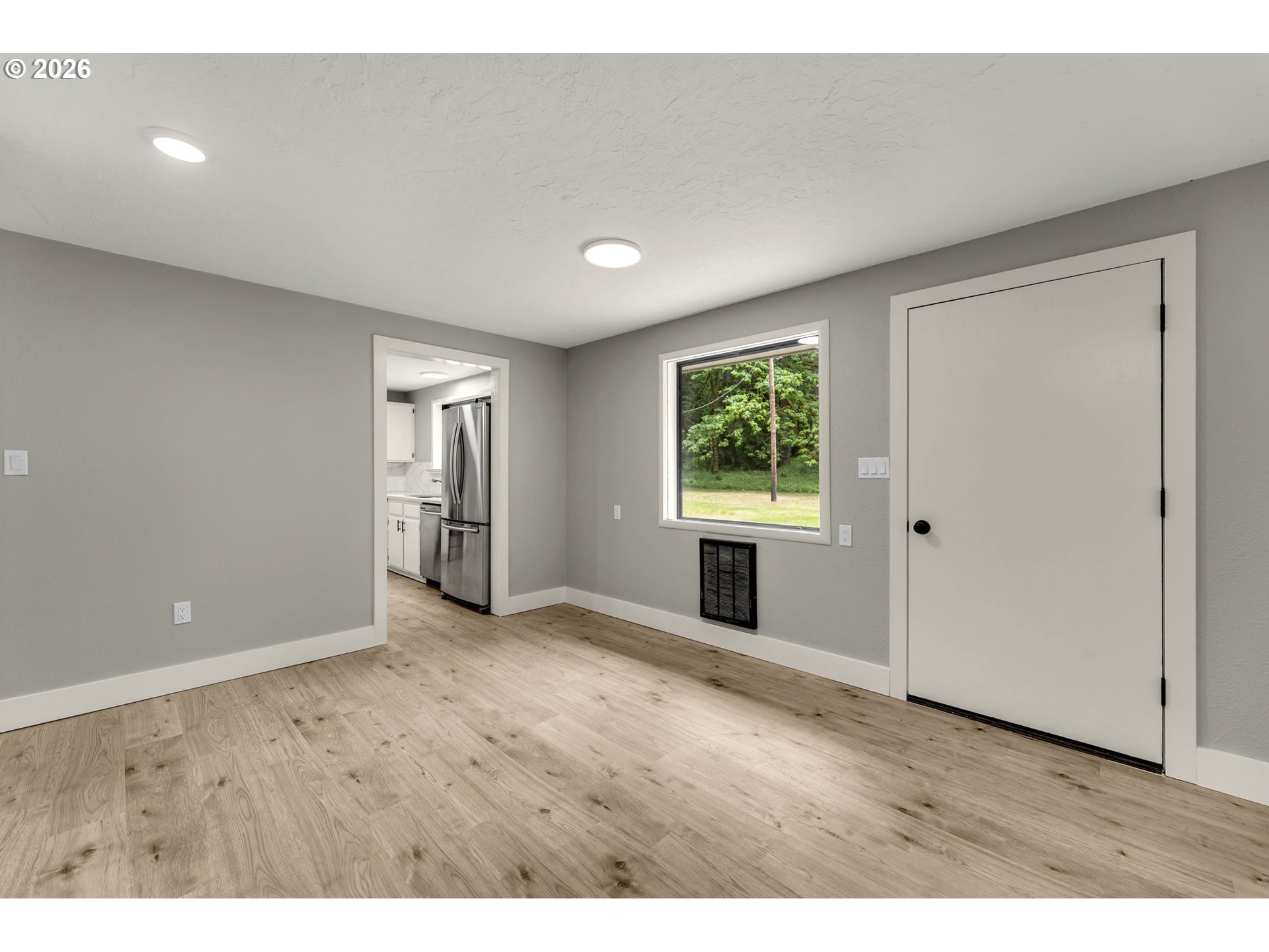 30921 Northwest Spencer Road La Center, WA 98642 - Photo 9 of 39 a view of an empty room with window and wooden floor