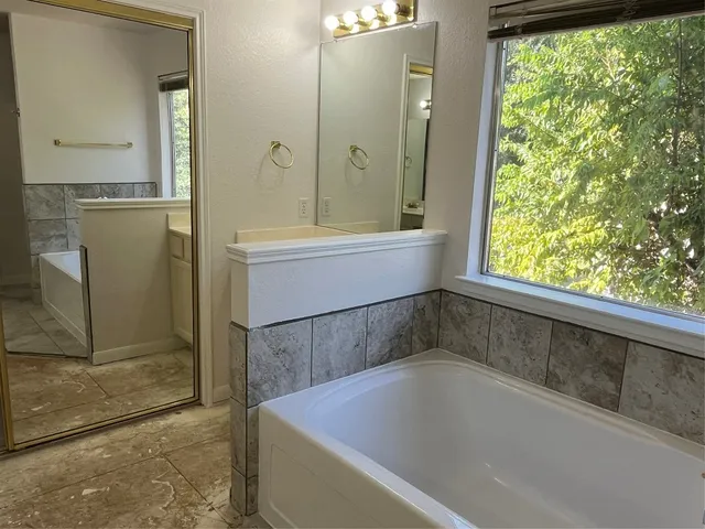 a bath tub sitting next to a shower