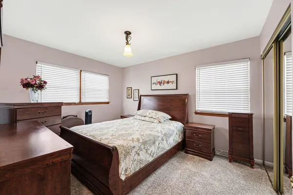 a bedroom with a bed and a desk
