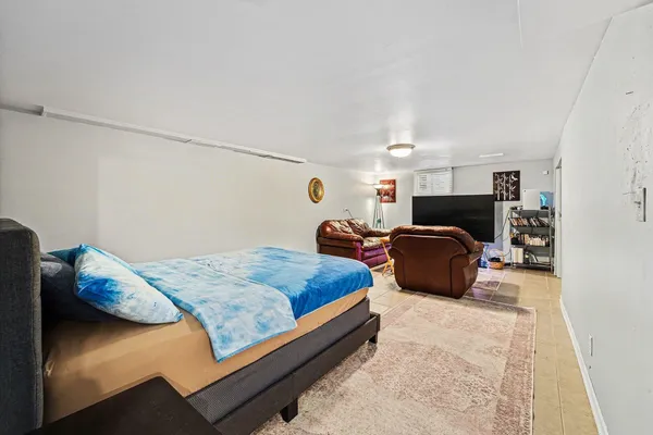 a bedroom with bed and window