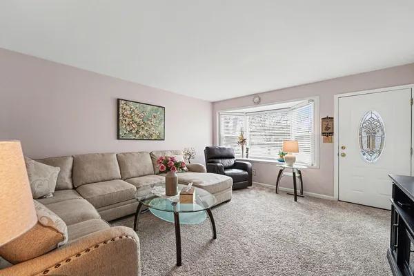 a living room with furniture and a large window