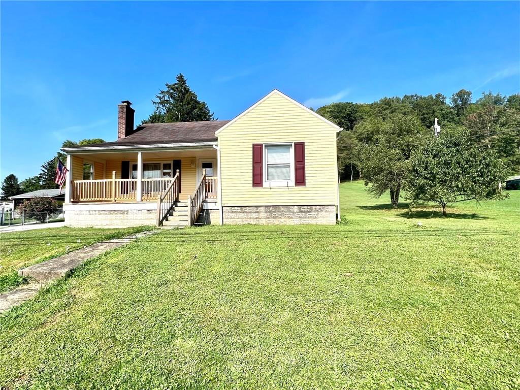 389 Mt Morris Road Mount Morris, PA 15349 - Photo 1 of 25 a front view of a house with garden