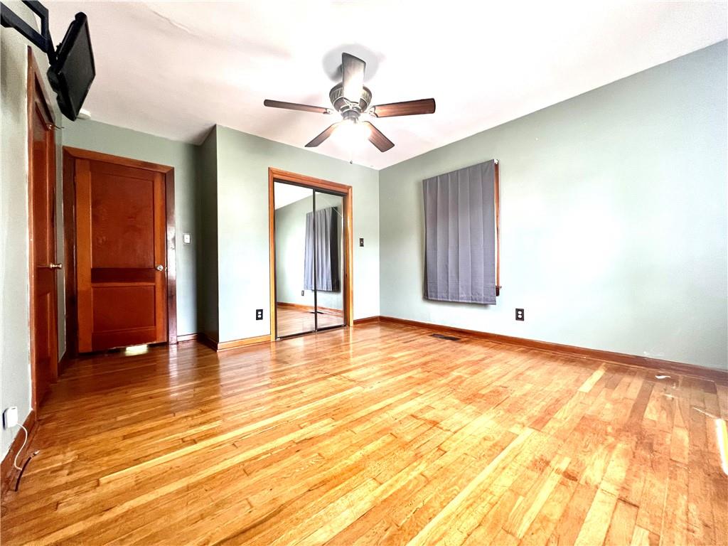 389 Mt Morris Road Mount Morris, PA 15349 - Photo 11 of 25 a view of an empty room with wooden floor and a ceiling fan