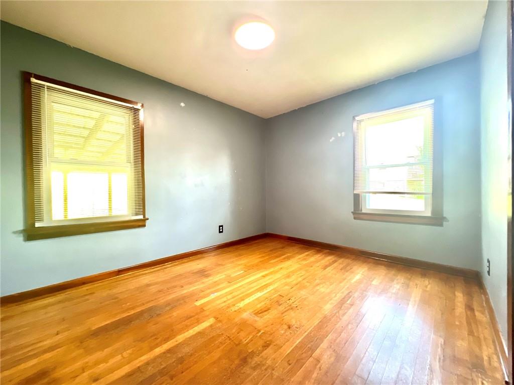 389 Mt Morris Road Mount Morris, PA 15349 - Photo 14 of 25 a view of an empty room with wooden floor and a window