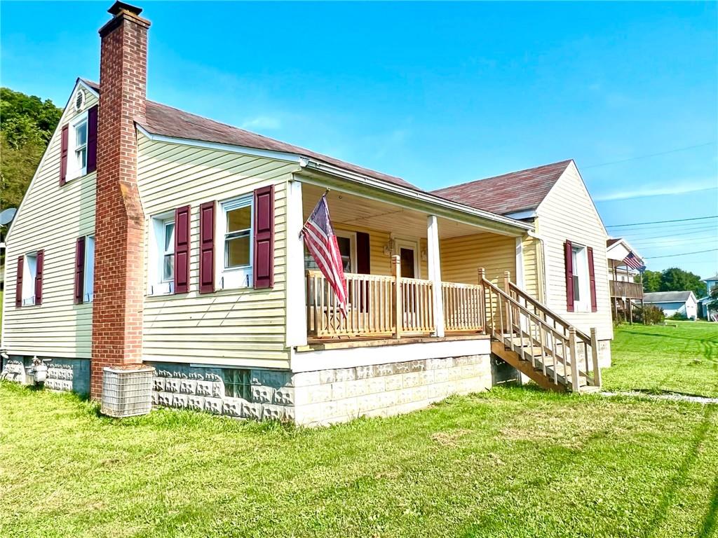 389 Mt Morris Road Mount Morris, PA 15349 - Photo 3 of 25 a front view of a house with a yard