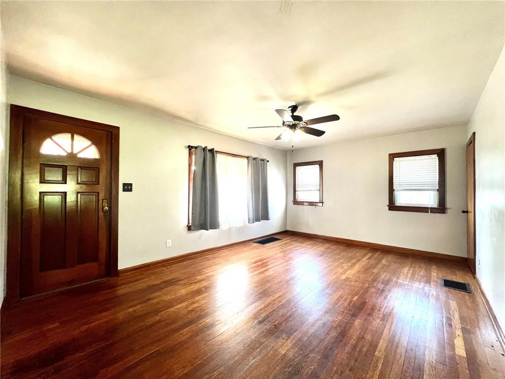 389 Mt Morris Road Mount Morris, PA 15349 - Photo 8 of 25 a view of an empty room with window and wooden floor