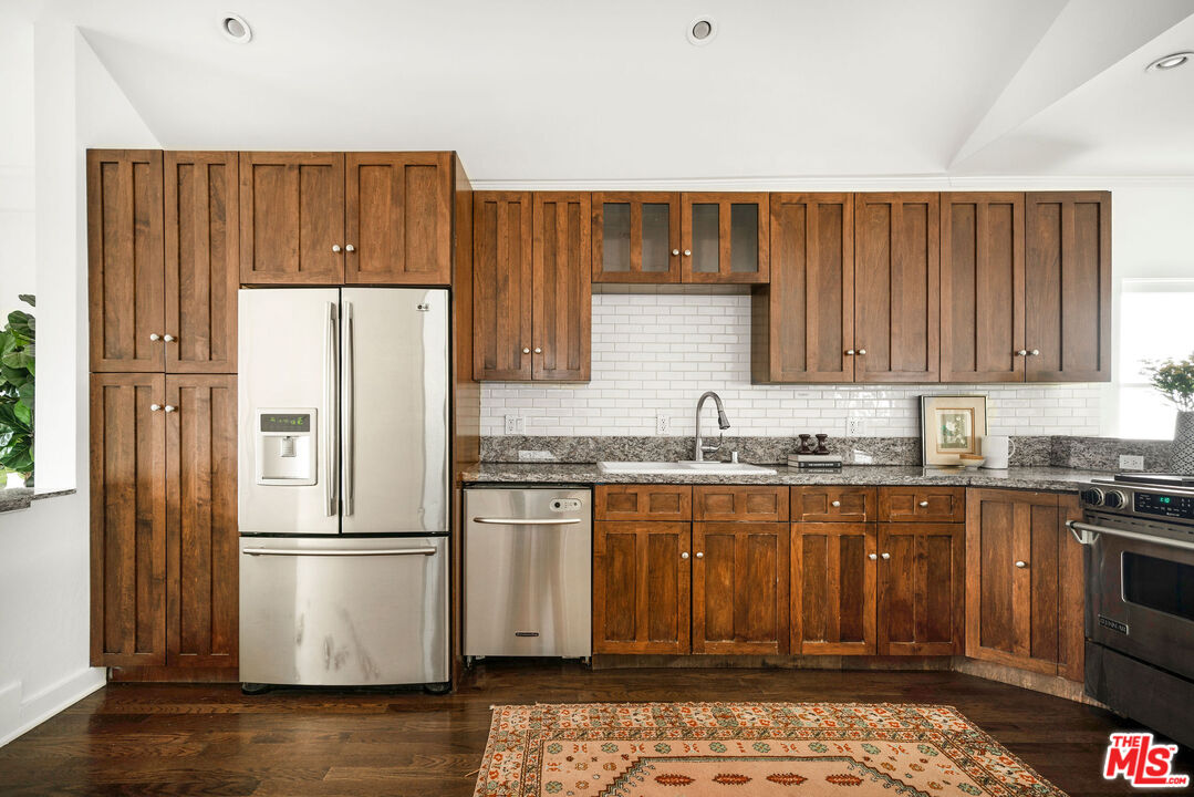 1205 Sanborn Avenue Los Angeles, CA 90029 - Photo 12 of 48 a kitchen with granite countertop wooden cabinets and stainless steel appliances