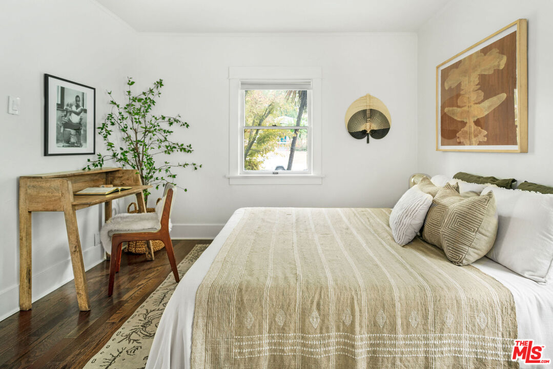 1205 Sanborn Avenue Los Angeles, CA 90029 - Photo 17 of 48 a bedroom with a bed and a table with paintings on the wall