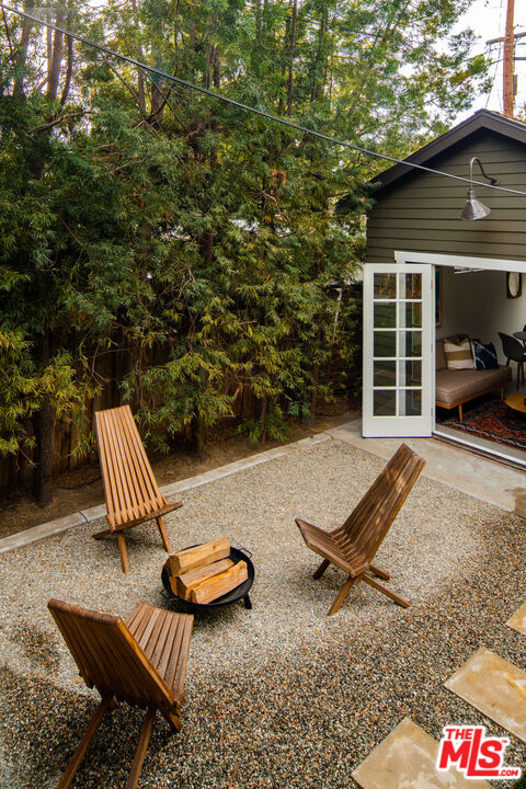 1205 Sanborn Avenue Los Angeles, CA 90029 - Photo 34 of 48 a view of a patio with couple of chairs in front of a house