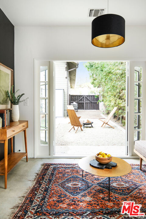 1205 Sanborn Avenue Los Angeles, CA 90029 - Photo 35 of 48 a living room with a couch and a floor to ceiling window