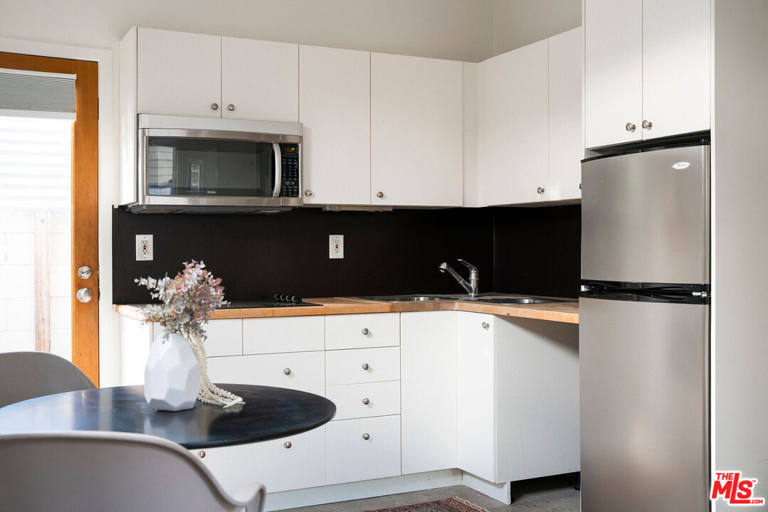 1205 Sanborn Avenue Los Angeles, CA 90029 - Photo 36 of 48 a kitchen with stainless steel appliances a sink and a refrigerator