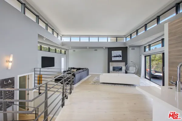 a bedroom with a bed window and a balcony