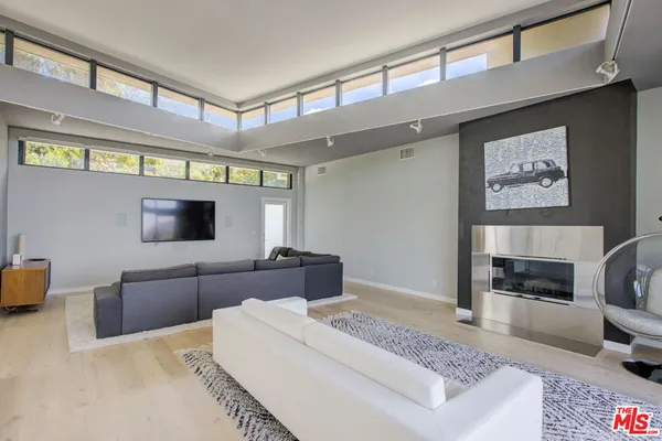 a kitchen with stainless steel appliances a refrigerator sink and white cabinets