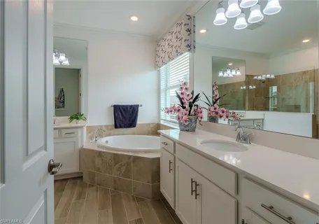 a bathroom with a granite countertop sink a large mirror and a shower