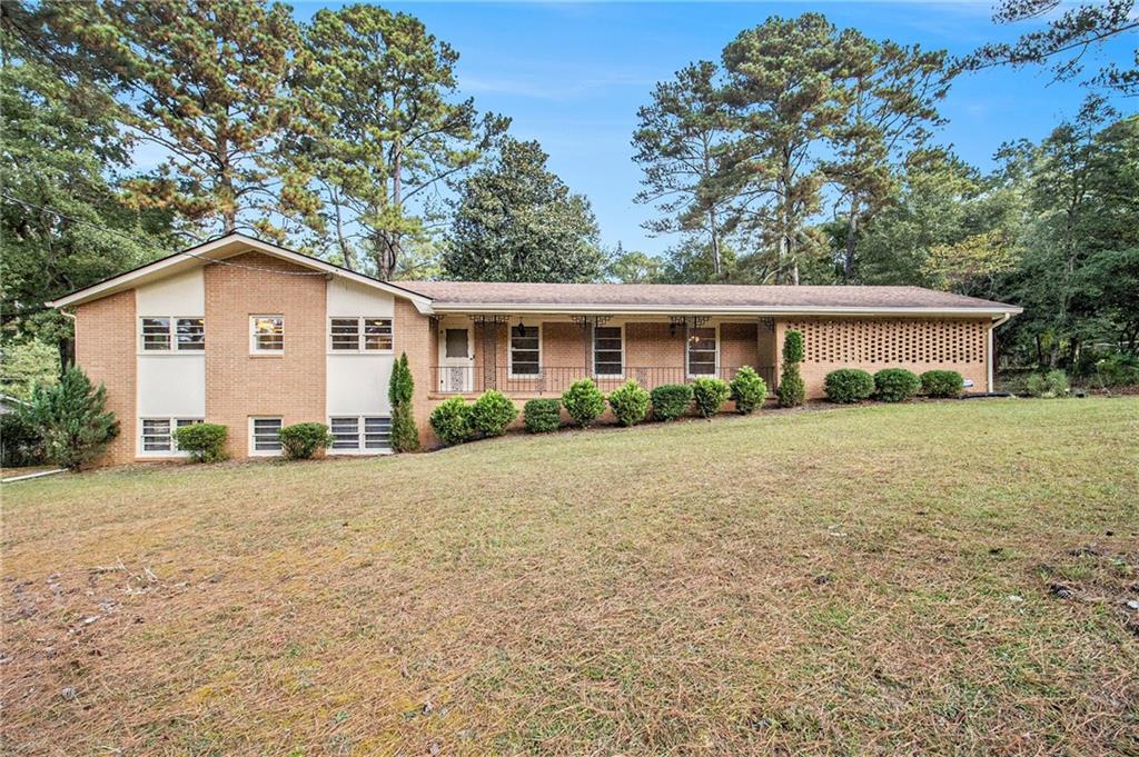 a view of house with outdoor space and garden
