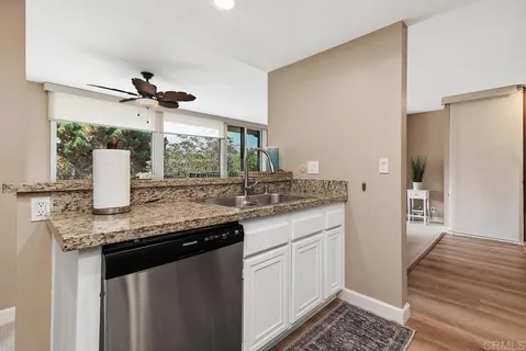 a kitchen with stainless steel appliances granite countertop a sink and cabinets