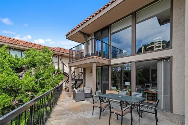 a view of a patio with table and chairs and potted plants