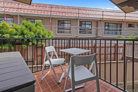 a bedroom with two beds and painting on the wall