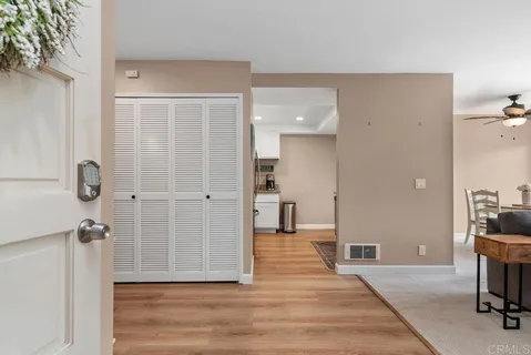 a living room with furniture a flat screen tv and a large window