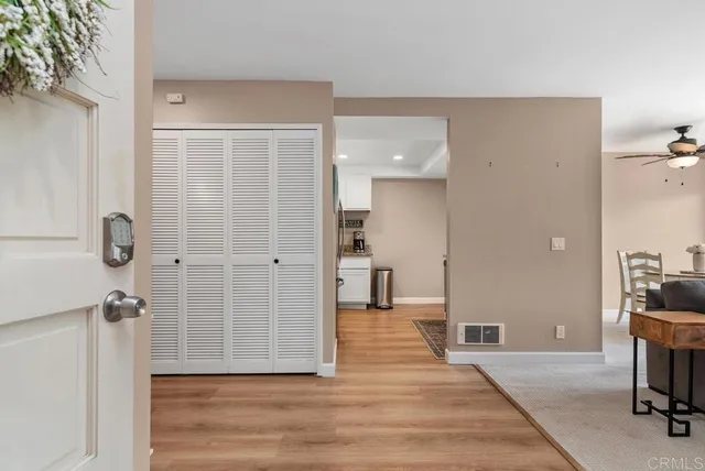 a living room with furniture a flat screen tv and a large window